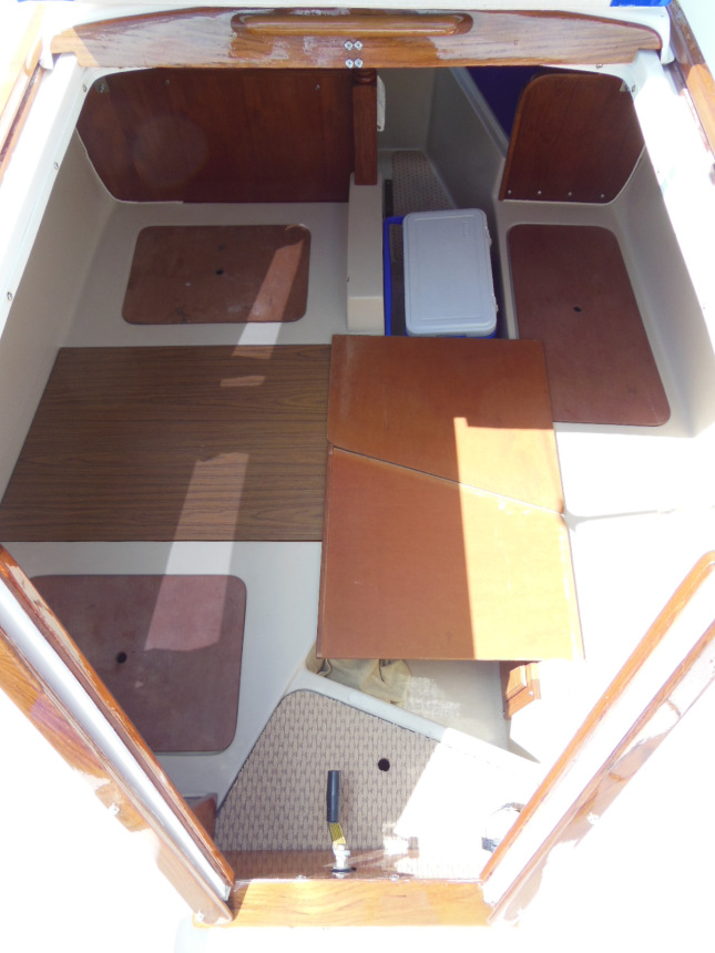 Salon set up to make the bed with Coleman 28 quart cooler and head cover boards