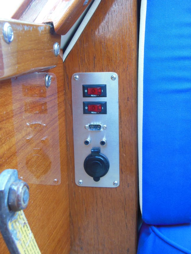 Custom accessory panel easily accessible next to the companionway