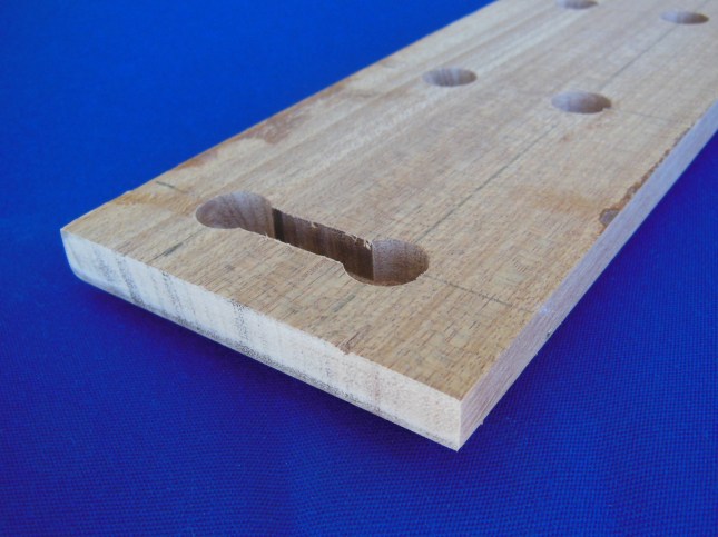 Back showing groove linking rows of holes