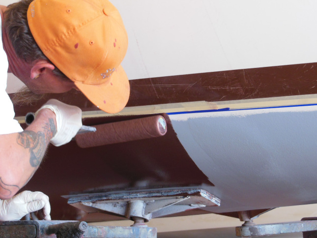 Applying bottom paint over the barrier coat