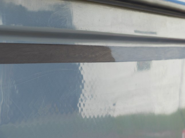 Masking tape removed where new gelcoat blended into old